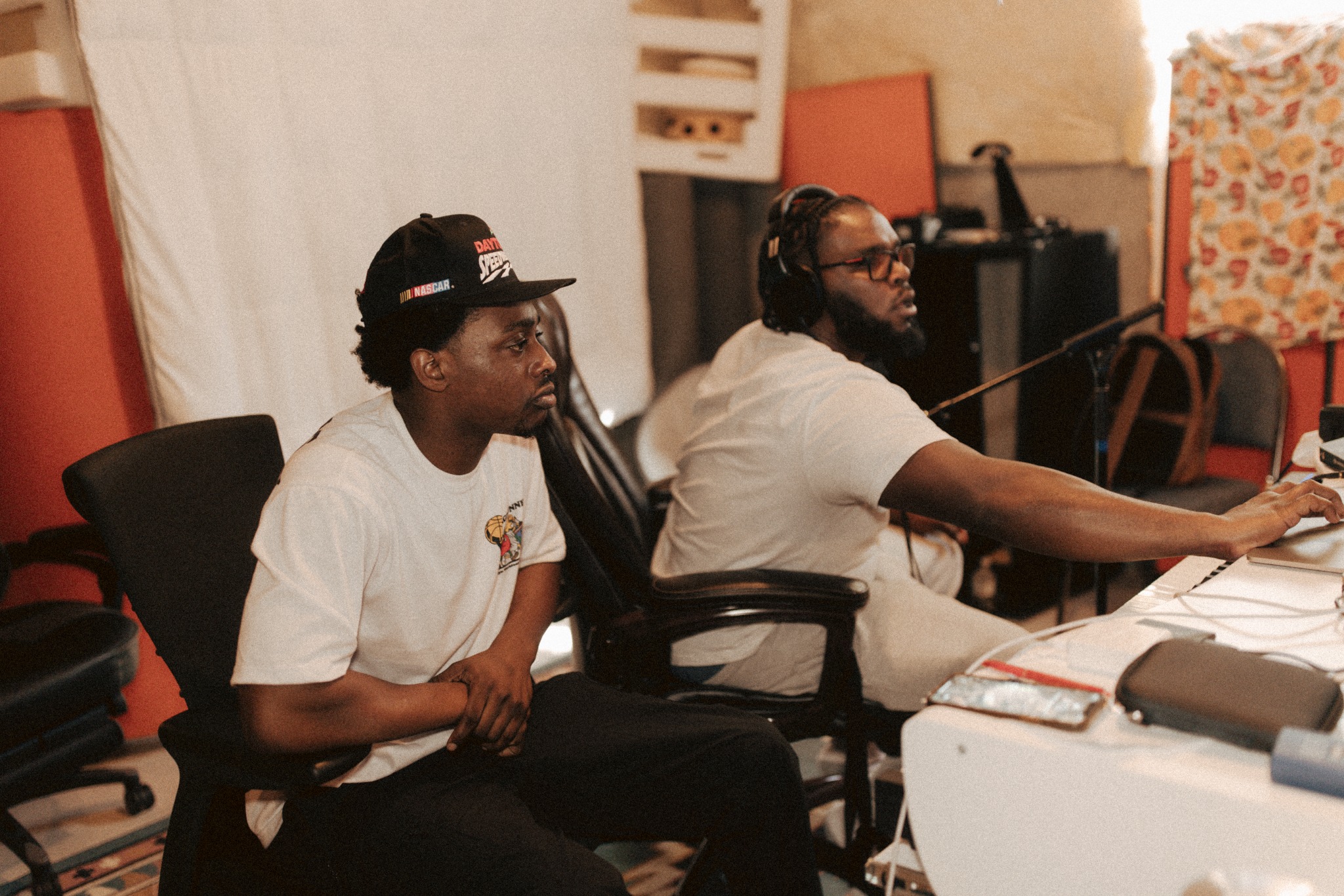 musicians collaborating at a studio workstation