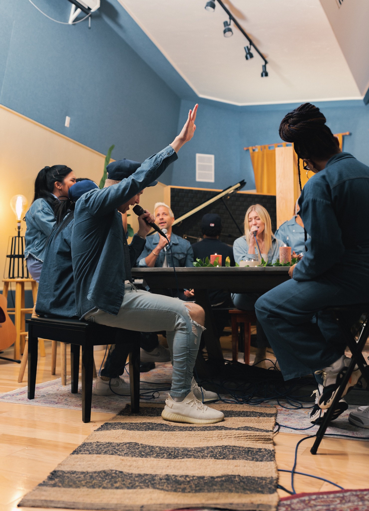musicians singing together around a table