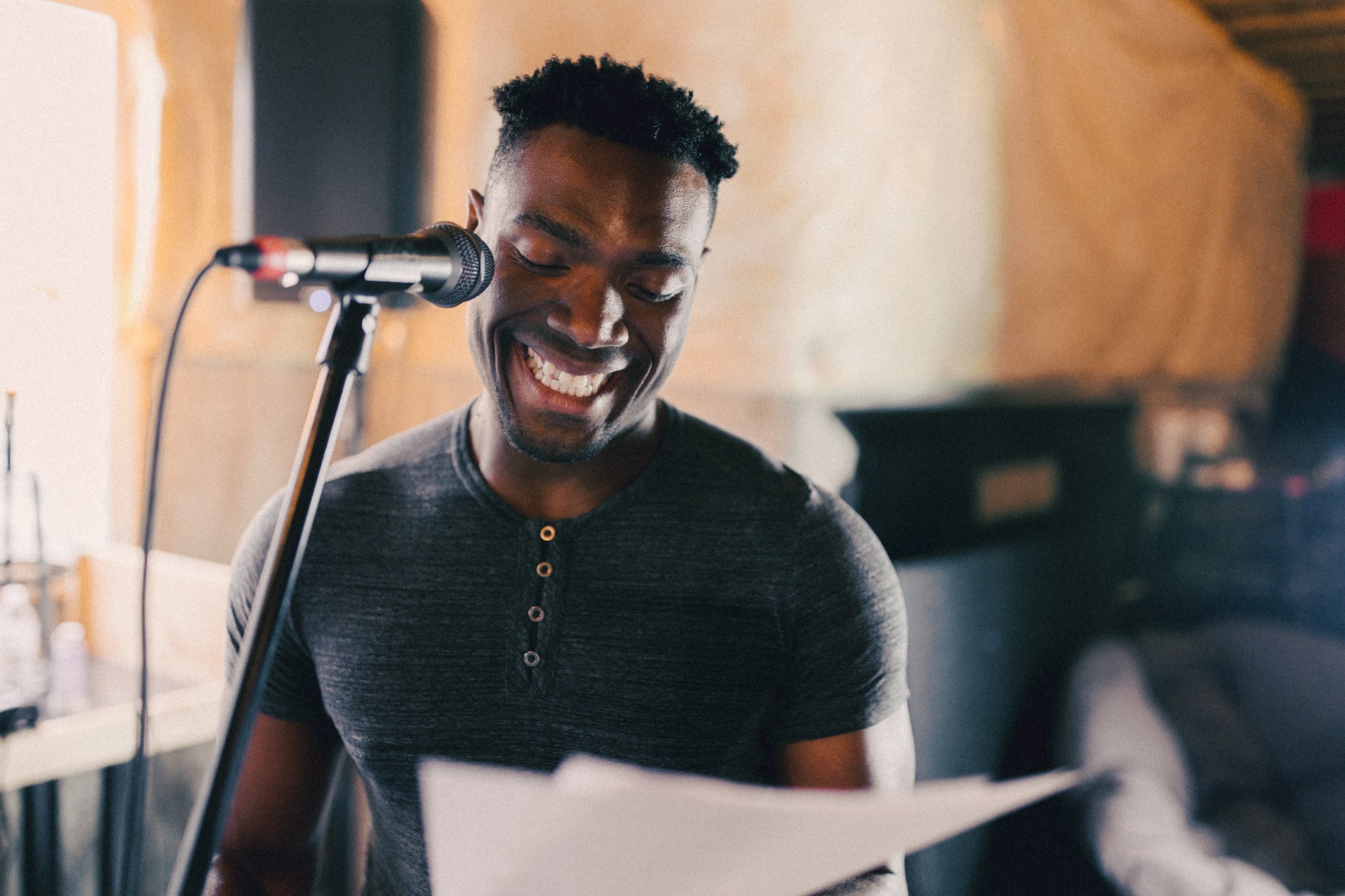 a vocalist recording with a lyric sheet