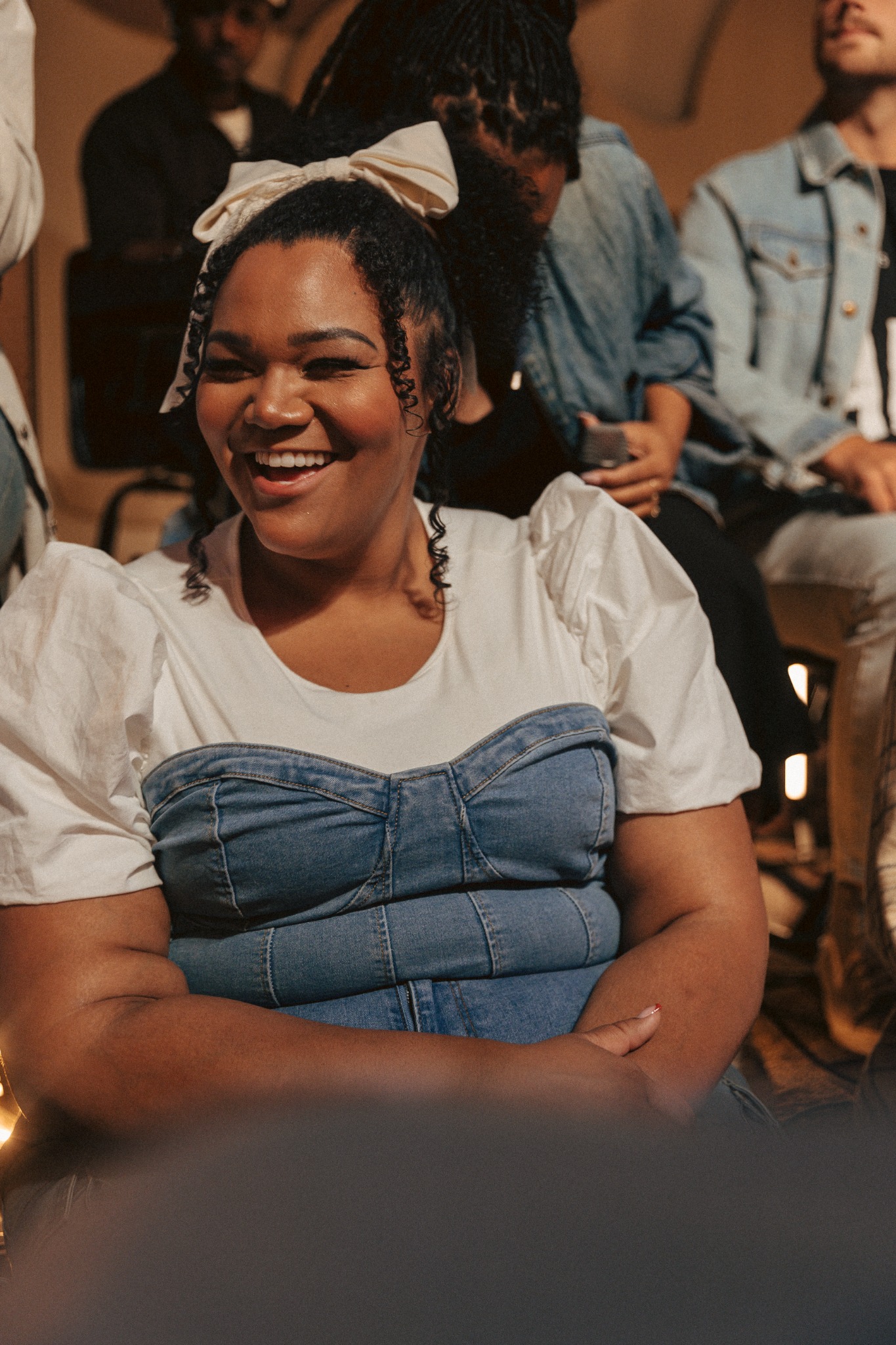 a smiling participant in denim overalls